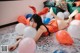 A woman laying on the floor surrounded by balloons.