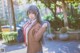 A woman in a school uniform is posing for a picture.