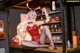 A woman in a bunny costume sitting on a counter.