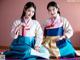 A couple of women sitting on top of a purple mat.