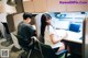 A man and a woman sitting at a desk in an office.